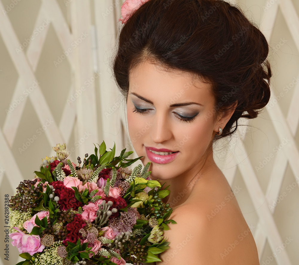 Studio portrait of a young beautiful bride with a wedding bouquet Studio portrait of a young beautiful bride with a wedding bouquet
