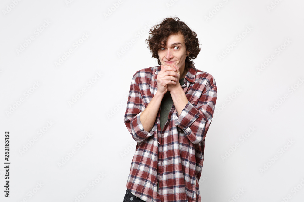 Portrait of funny excited young man in casual clothes looking aside, put hands prop up on chin isolated on white background in studio. People sincere emotions, lifestyle concept. Mock up copy space. Portrait of funny excited young man in casual clothes looking aside, put hands prop up on chin isolated on white background in studio. People sincere emotions, lifestyle concept. Mock up copy space.