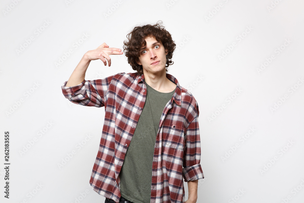 Shocked concerned young man in casual clothes point fingers to head as if he about shoot himself isolated on white background in studio. People sincere emotions, lifestyle concept. Mock up copy space. Shocked concerned young man in casual clothes point fingers to head as if he about shoot himself isolated on white background in studio. People sincere emotions, lifestyle concept. Mock up copy space.