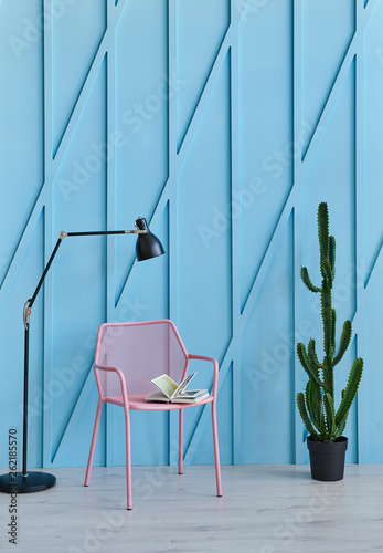 Decorative blue background and modern home object chair table and vase of plant.
