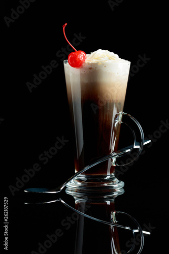 Layered coffee cocktail with whipped cream.