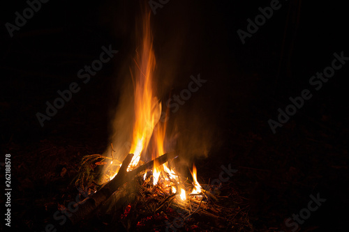 Bonfire in the night. Beautiful orange sparkles on a black background.