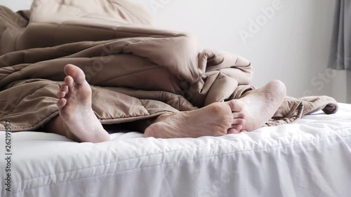 Young gay male couple naked in bed together, intimate. About to have sex under blanket. Happy gay friendship, relationship, pride concept.