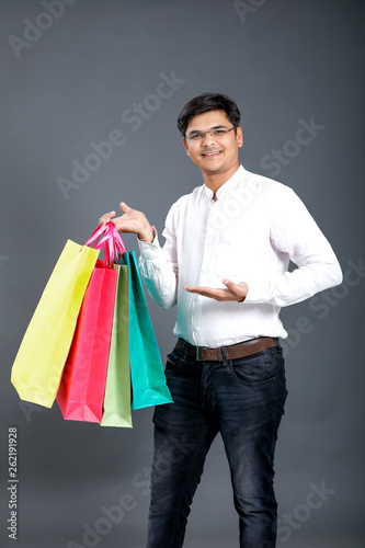 Young Indian man with shopping bags