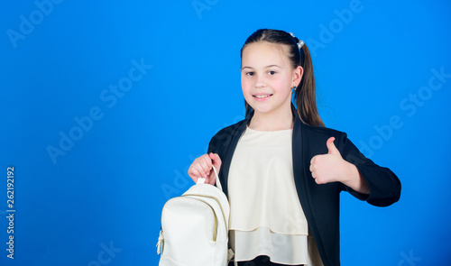 Learn how fit backpack correctly. Girl little fashionable cutie carry backpack. Kids fashion trend concept. Schoolgirl formal style clothes with small cute backpack. Do not forget your backpack