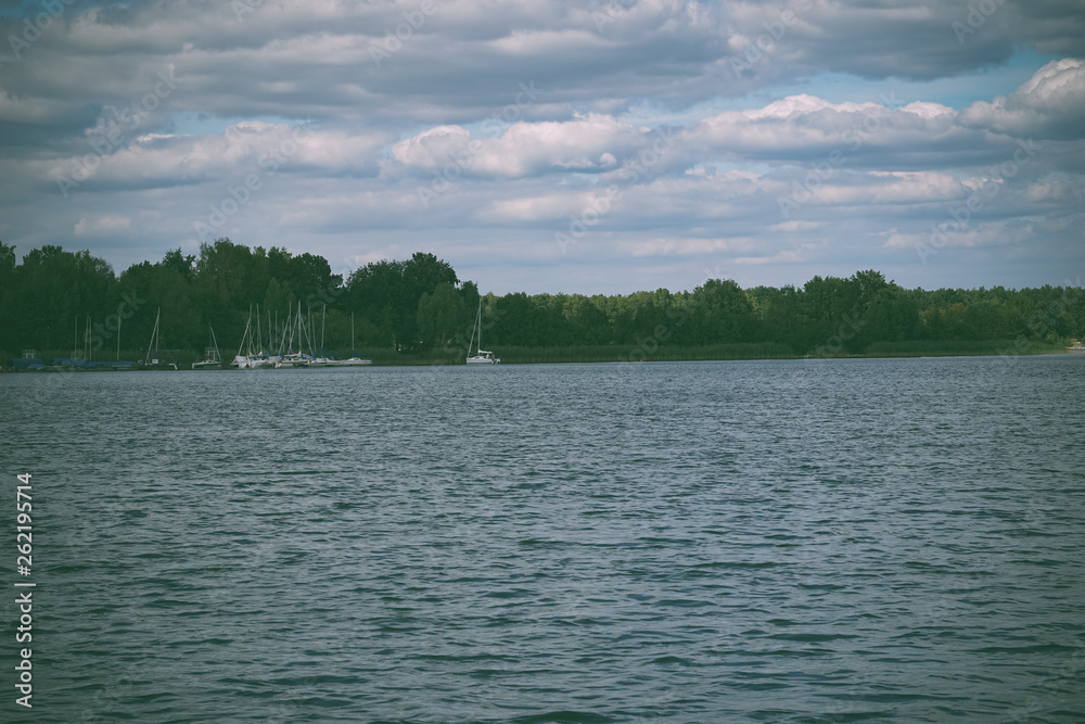 Lake landscape with cloud reflections. Blue sky and reflected in the lake water landscape Lake landscape with cloud reflections. Blue sky and reflected in the lake water landscape