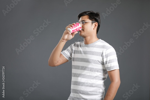 Young indian man drinking a water