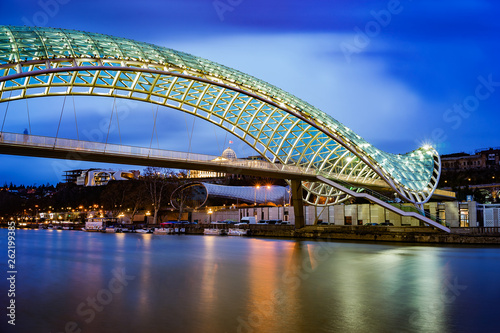 The bridge of peace in Tbilisi, Georgia. Beautiful lighting of the friendship bridge by night. The main attraction of the town.