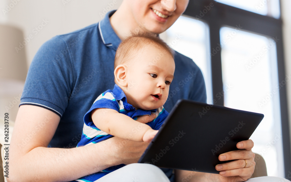 mixed-race family, parenthood and people concept - happy father and little baby son with tablet pc computer at home mixed-race family, parenthood and people concept - happy father and little baby son with tablet pc computer at home