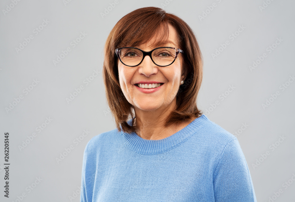 vision and old people concept - portrait of smiling senior woman in glasses over grey background vision and old people concept - portrait of smiling senior woman in glasses over grey background