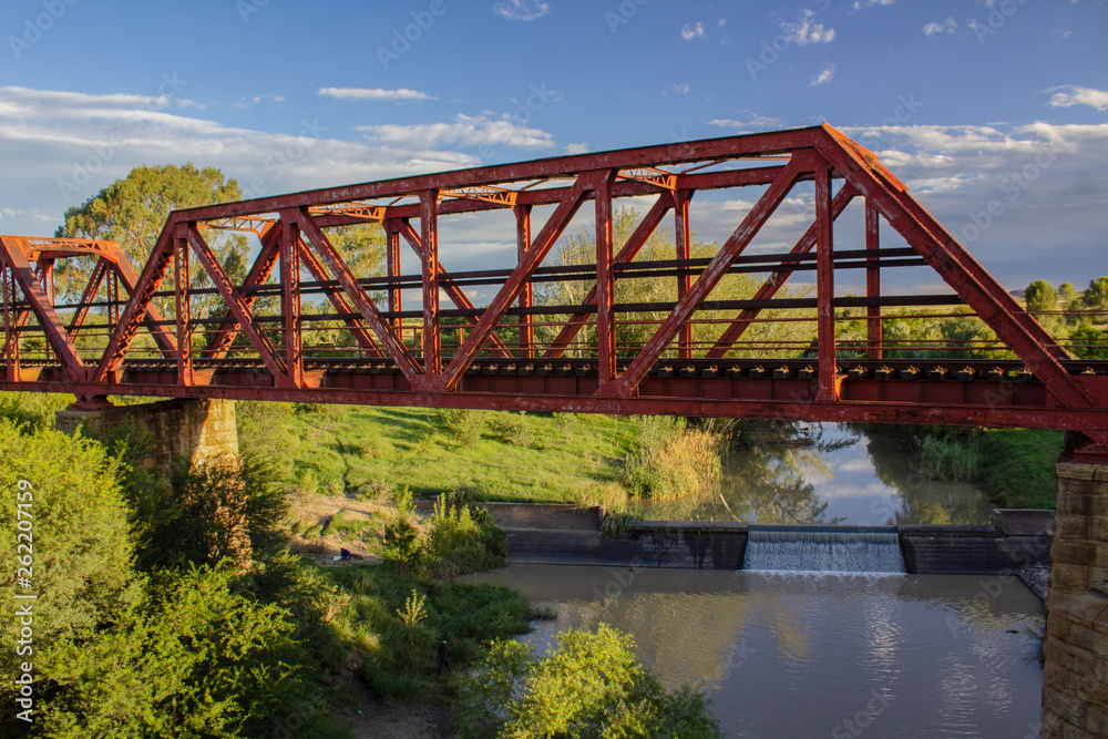 Old steel bridge over a small African river Old steel bridge over a small African river