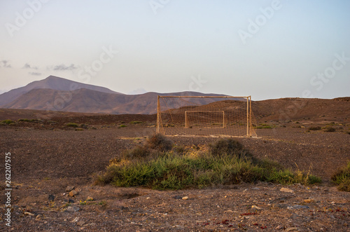 Abandoned soccer goal in the desert at sunset