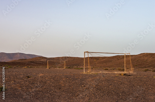 Abandoned soccer goal in the desert at sunset