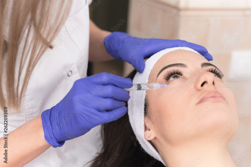 Woman having corrective aesthetic procedure Woman having corrective aesthetic procedure