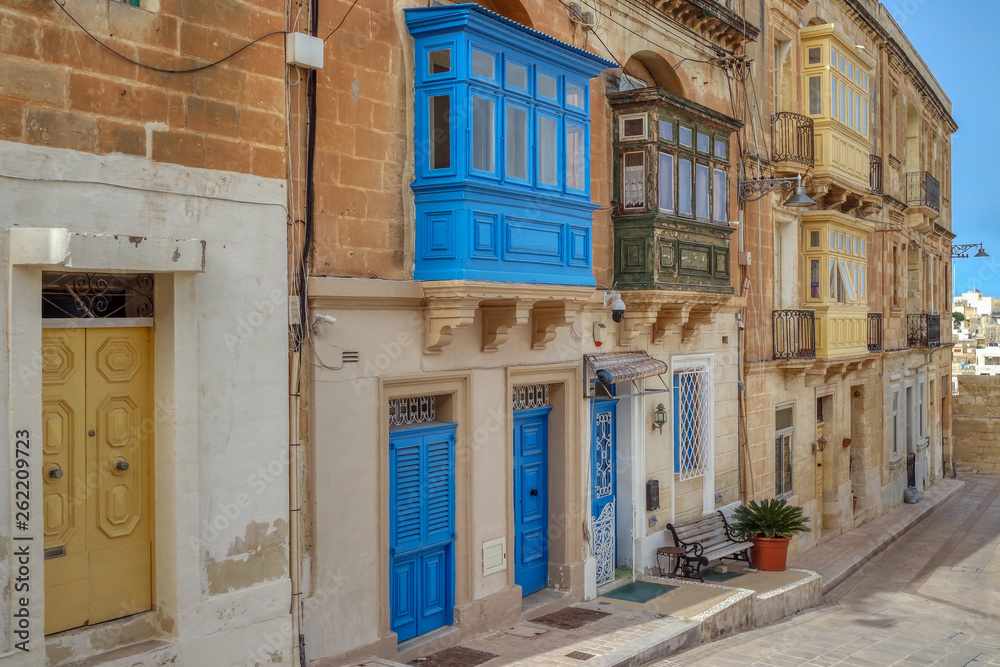 Street with old buildings and colorful Maltese balconies, Birgu (Vittoriosa), Malta