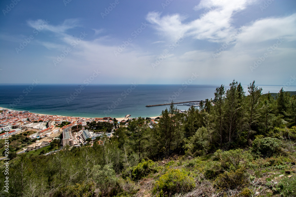 aerial view of Sesimbra village with blue sky in background, Portugal