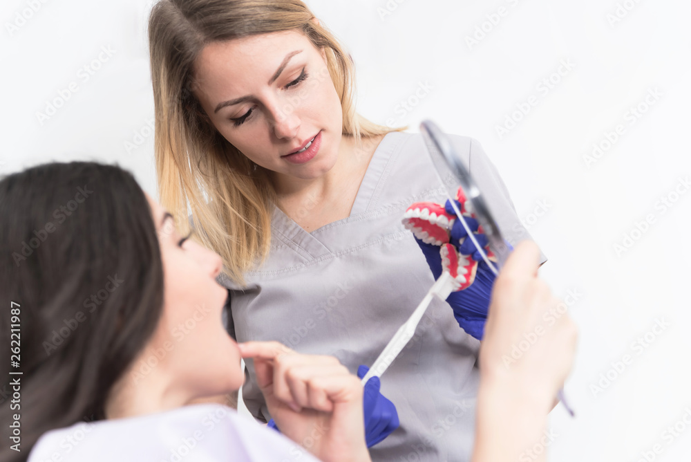 Dentist explaining to her patient Dentist explaining to her patient