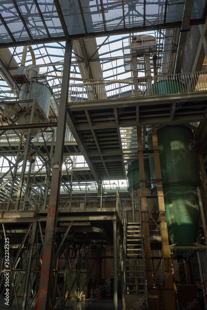 Industrial background, old abandoned factory hall with stairs and day light