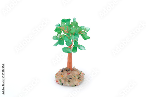 money tree of green stone with coins on a white background.