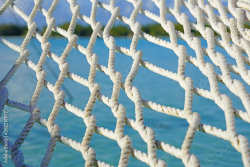 Hammock with a view, planted in the azure waters of the Bora Bora lagoon, French Polynesia