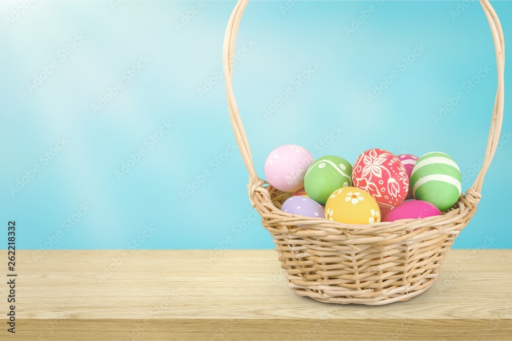 Easter basket filled with colorful eggs on a white background Easter basket filled with colorful eggs on a white background