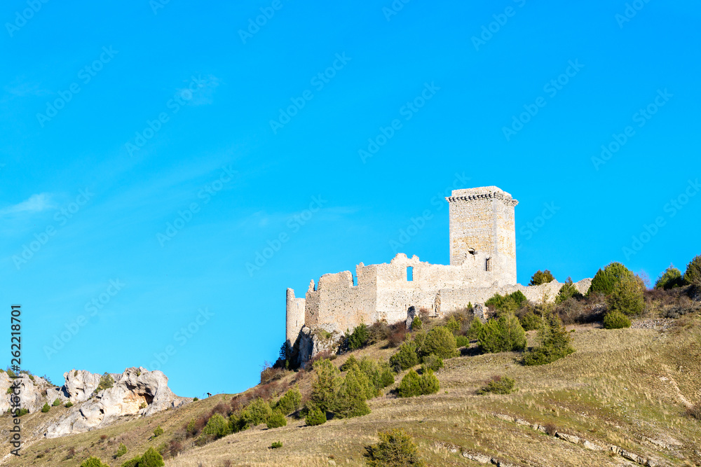 castle in the mountains with blue sky at background