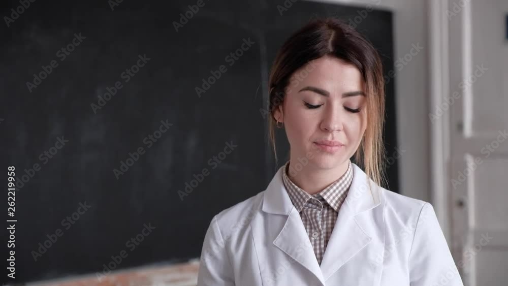 Portrait of a young girl, laboratory assistant, in a white medical gown, a girl is in a laboratory of the Soviet era Portrait of a young girl, laboratory assistant, in a white medical gown, a girl is in a laboratory of the Soviet era