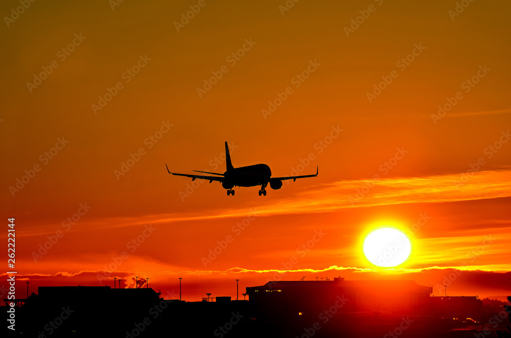 Airplane landing to sunset