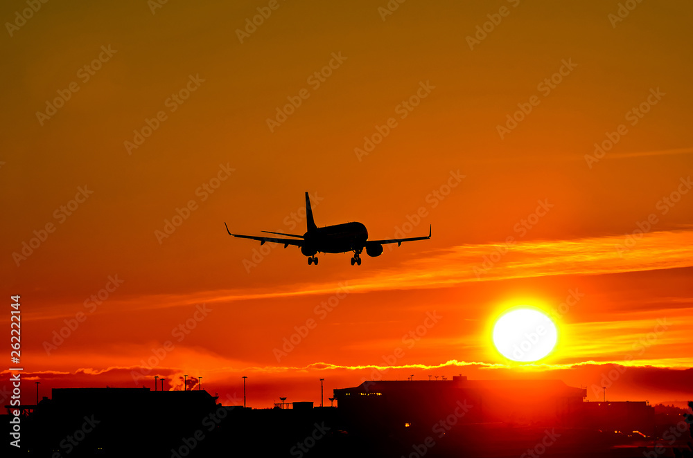 Airplane landing to sunset Airplane landing to sunset