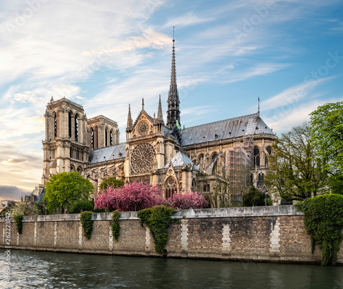 Evening view of Notre-Dame Cathedral from riverside. Copy space in sky.