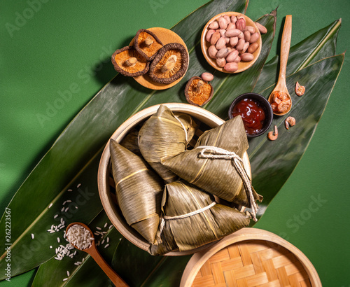 Close up, copy space, top view, flat lay. Famous asian chinese tasty handmade food in duan wu festival, steamed rice dumplings shaped like pyramidal ingredients photo