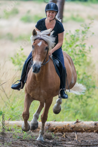 Woman horseback riding © citikka