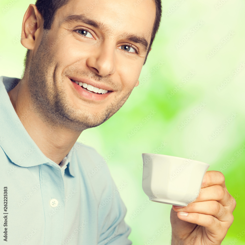 Happy smiling man drinking coffee, outdoors Happy smiling man drinking coffee, outdoors