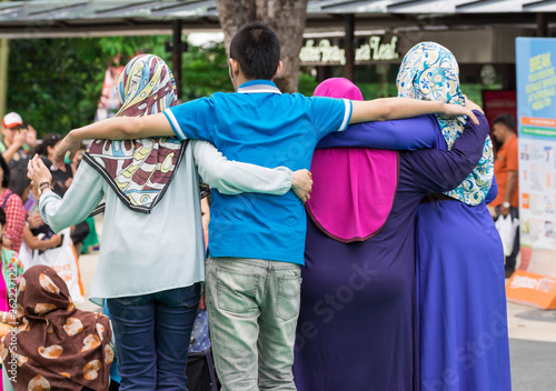Racial harmony pose of several muslim women in Sentosa Merlion Park, Singapore, March 15 2019