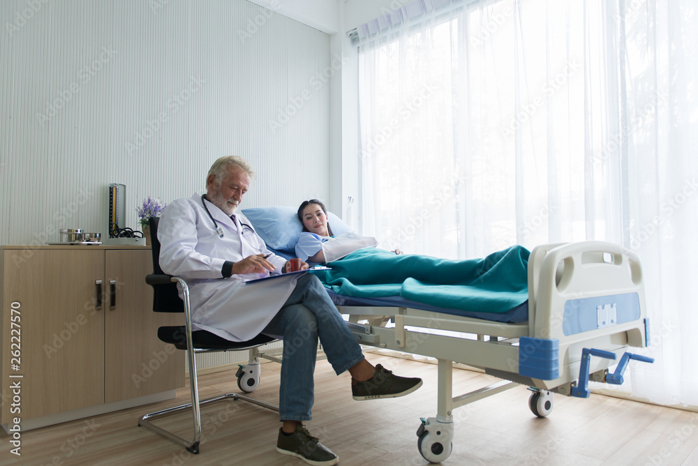 Happy patient asian women with senior doctor giving a consultation and encouragement  at hospital