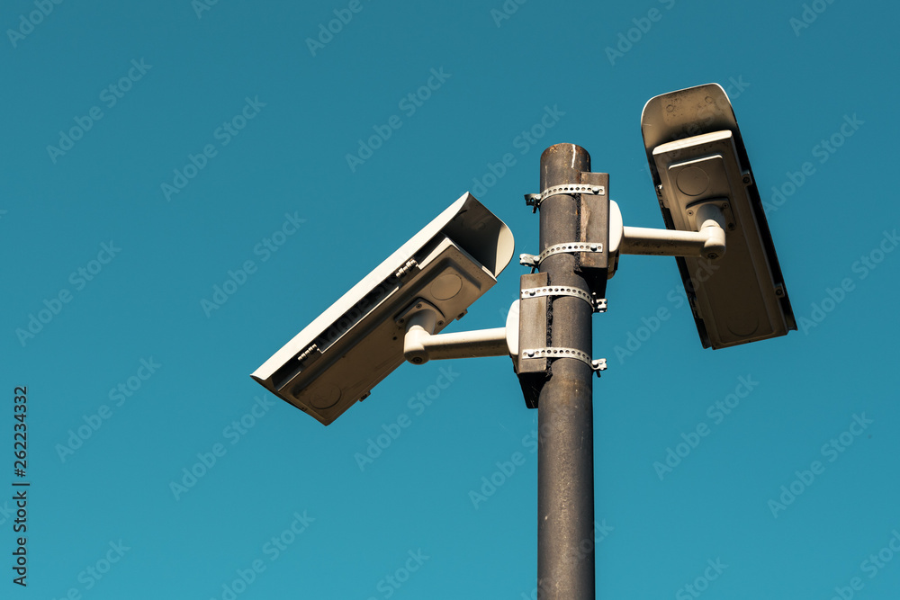 Security cameras with blue sky as background Security cameras with blue sky as background