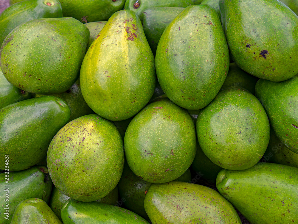 Close-up of a heap of avocados, photographed at the traditional local market of the colonial town of Villa de Leyva, in the Andean mountains of central Colombia.