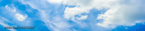 Beautiful panoramic vivid vibrant blue sky with white clouds on a sunny day for web banner.