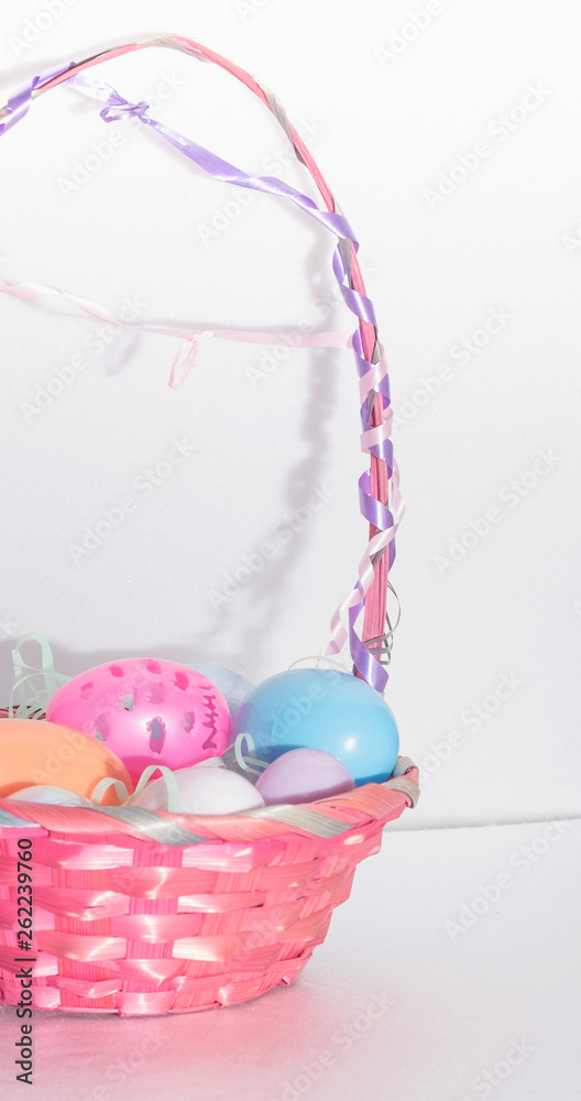 colored easter eggs in a wicker basket