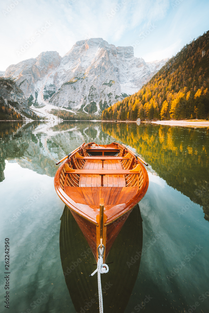 Traditional rowing boat at Lago di Braies at sunrise in fall, South Tyrol, Italy