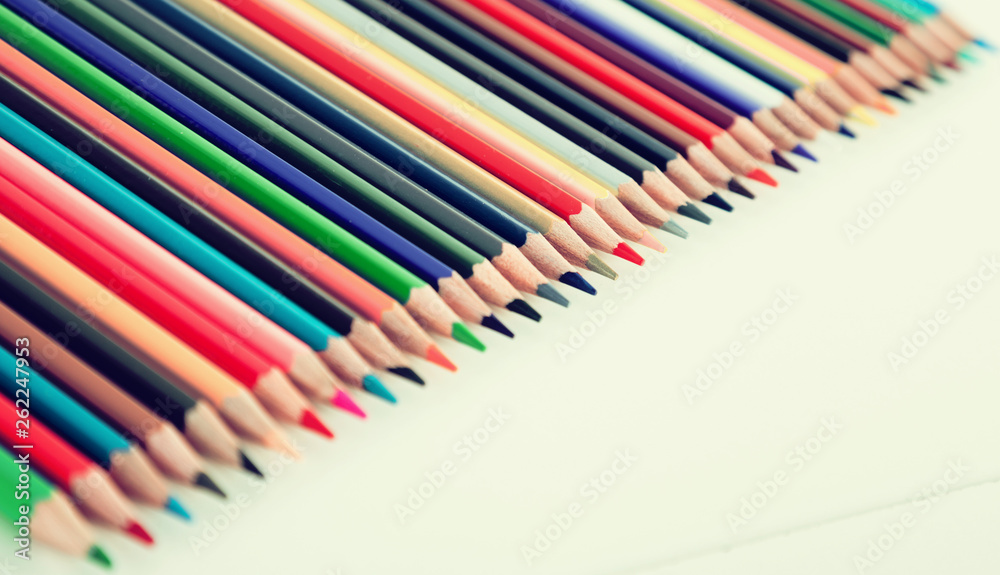 colored pencils lying in row