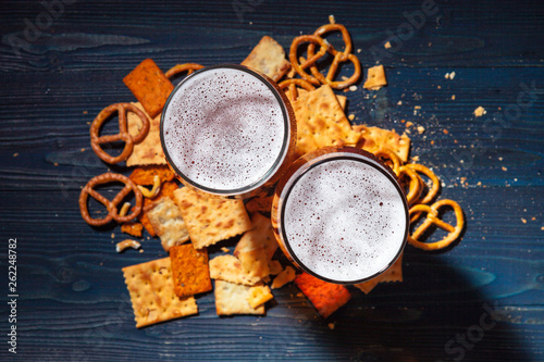 A selection of beer and snacks on wooden background photo