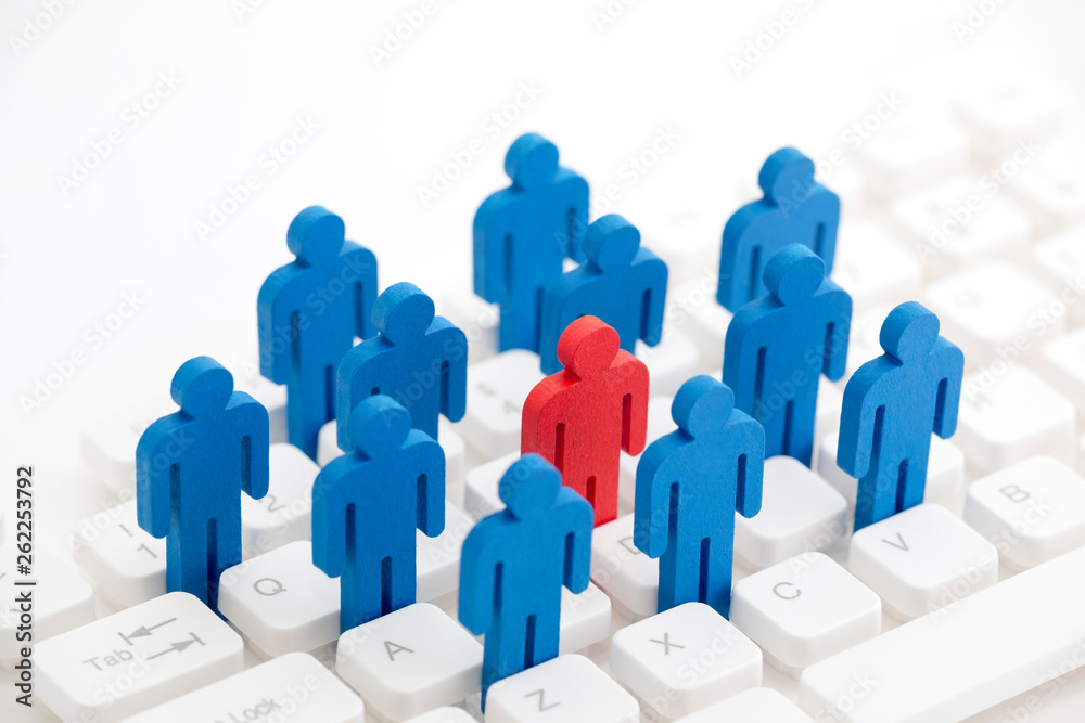 Unique person in the crowd on computer keyboard