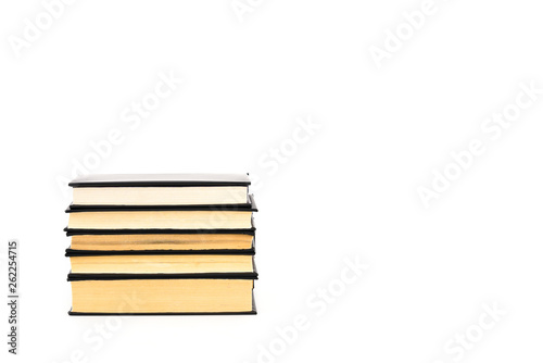 Old black hardcover books with yellow pages isolated on white