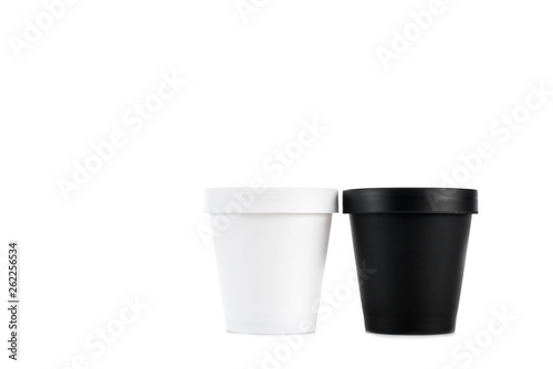 White and black plastic cups isolated on white