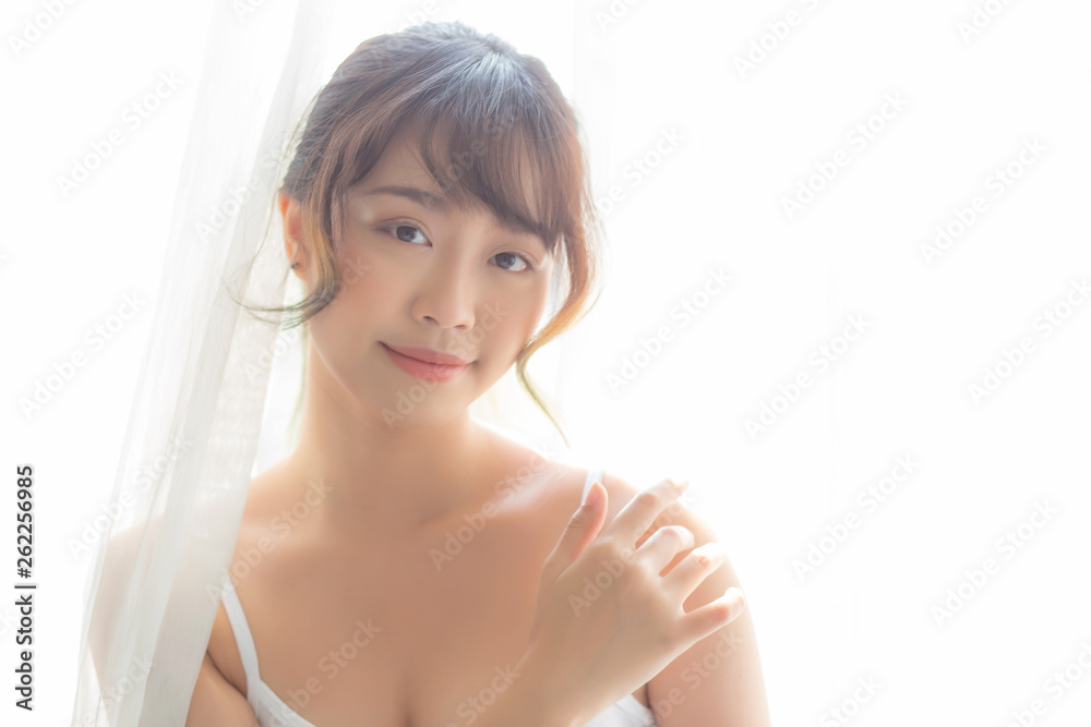 Portrait of beautiful young asian woman makeup of cosmetic, girl hand touch shoulder and smile attractive, face of beauty perfect with wellness in the bedroom with skin care and healthcare concept. Portrait of beautiful young asian woman makeup of cosmetic, girl hand touch shoulder and smile attractive, face of beauty perfect with wellness in the bedroom with skin care and healthcare concept.