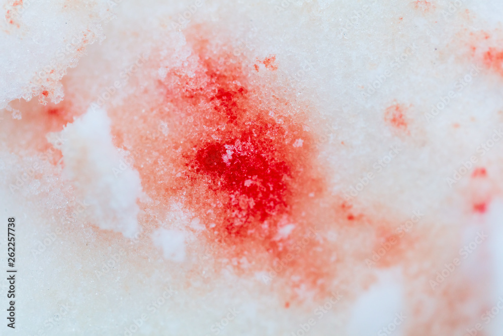 Red blood on white snow as a background