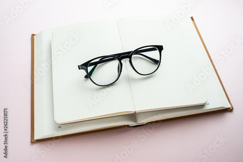 Glasses and book reading background material