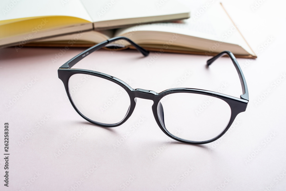 Glasses and book reading background material Glasses and book reading background material