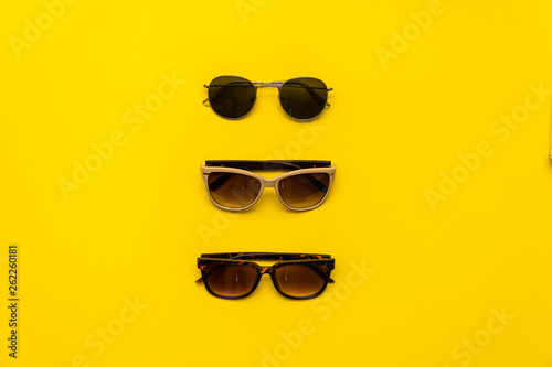 items for rest in hot countries on yellow background. copy space for text in travel advertising.travel time. Items for summer vacation. summer flat lay. top view. different sunglasses
